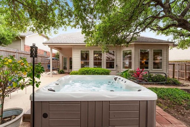 exterior space featuring a fenced backyard and a hot tub