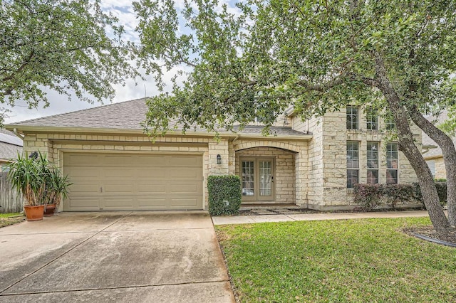 404 Scarlet Maple Dr, Cedar Park, TX 78613 - view of front facade featuring driveway, a garage, stone siding, and a front lawn