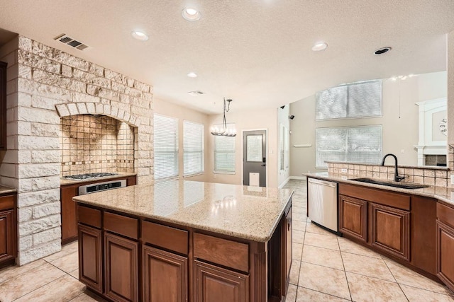 404 Scarlet Maple Dr, Cedar Park, TX 78613 - kitchen featuring light tile patterned flooring, an inviting chandelier, a sink, a textured ceiling, and stainless steel appliances
