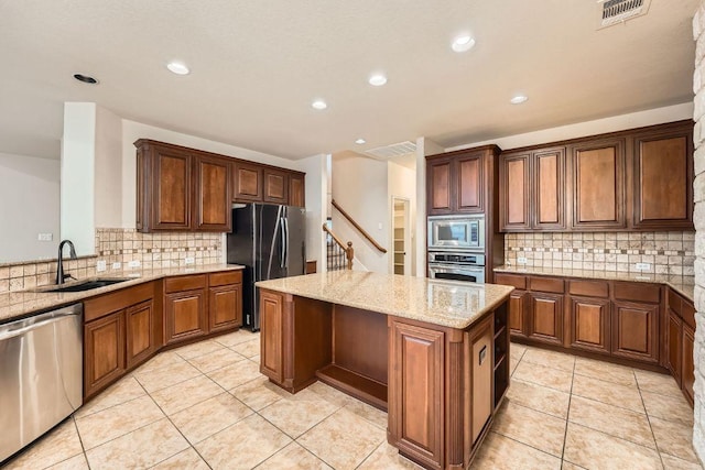 404 Scarlet Maple Dr, Cedar Park, TX 78613 - kitchen featuring visible vents, decorative backsplash, a kitchen island, a sink, and appliances with stainless steel finishes