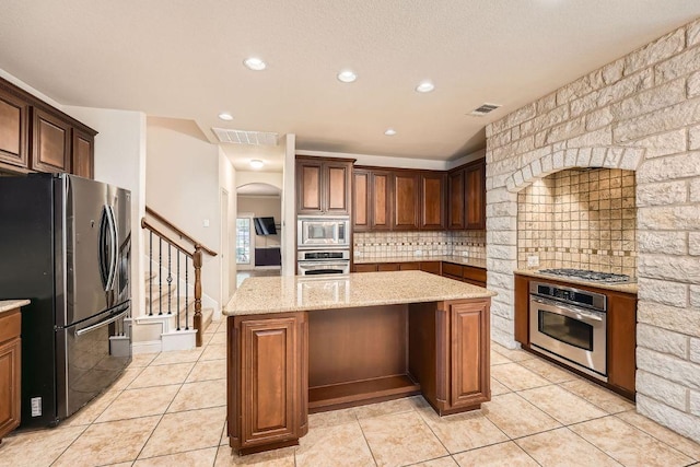 404 Scarlet Maple Dr, Cedar Park, TX 78613 - kitchen featuring a kitchen island, stainless steel appliances, visible vents, and decorative backsplash