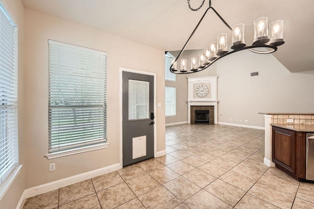 404 Scarlet Maple Dr, Cedar Park, TX 78613 - kitchen featuring light tile patterned floors, a chandelier, a healthy amount of sunlight, and visible vents
