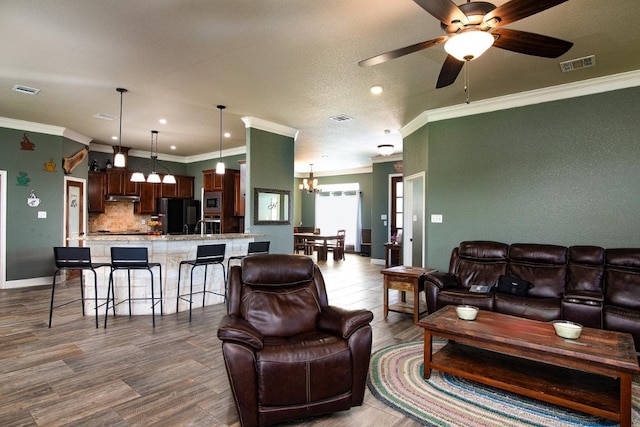 1066 Vista Dr, Salado, TX 76571 - living area featuring crown molding, a chandelier, ceiling fan, dark wood-style flooring, and recessed lighting
