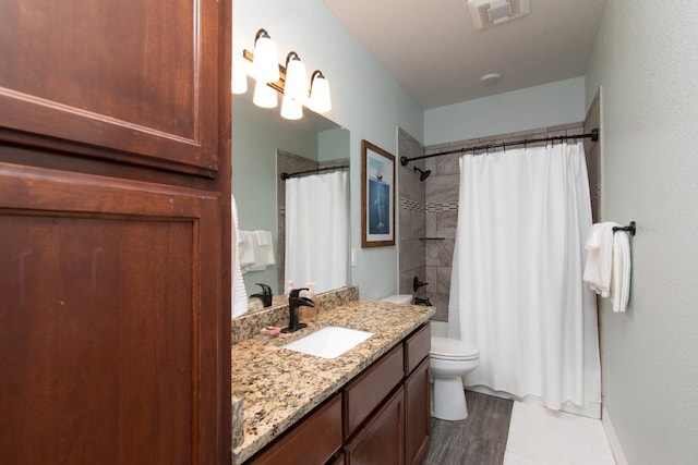1066 Vista Dr, Salado, TX 76571 - bathroom with toilet, vanity, shower / tub combo with curtain, and wood finished floors