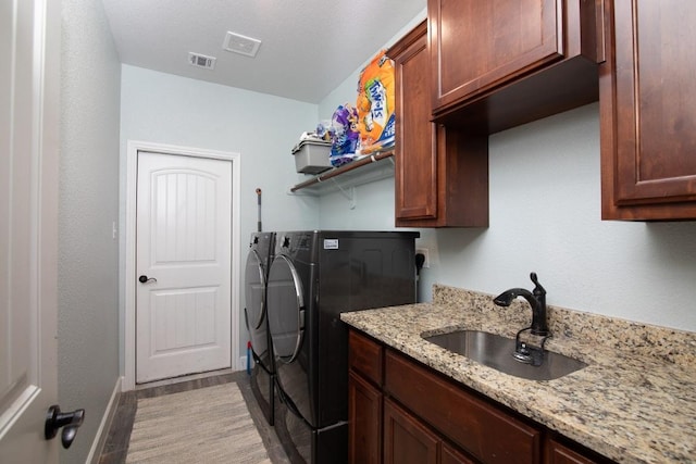 1066 Vista Dr, Salado, TX 76571 - washroom featuring washing machine and clothes dryer, cabinet space, and baseboards
