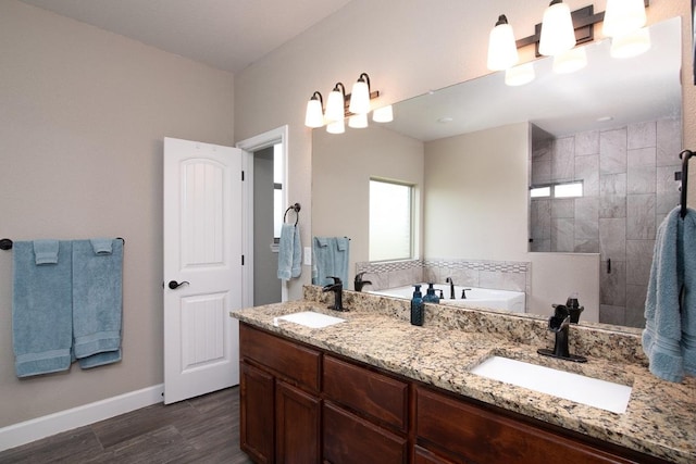 1066 Vista Dr, Salado, TX 76571 - full bath featuring wood finished floors, a tile shower, baseboards, a bath, and double vanity