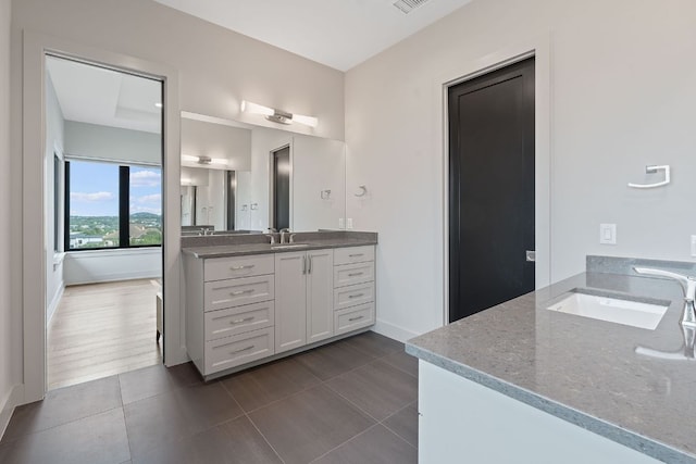 18304 Cedar Sage Ct, Lago Vista, TX 78645 - bathroom with vanity, baseboards, tile patterned flooring, and visible vents