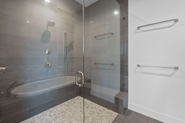 bathroom featuring baseboards and a tile shower