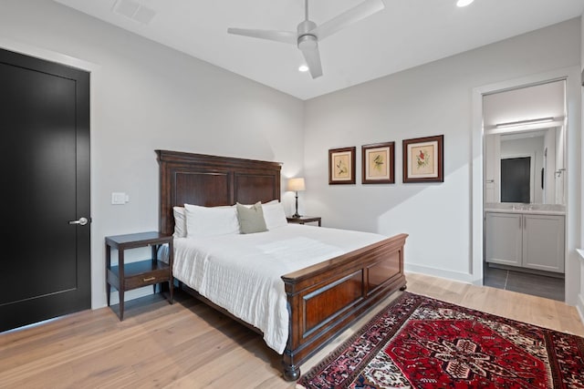 bedroom featuring light wood-style floors, recessed lighting, ensuite bath, and visible vents