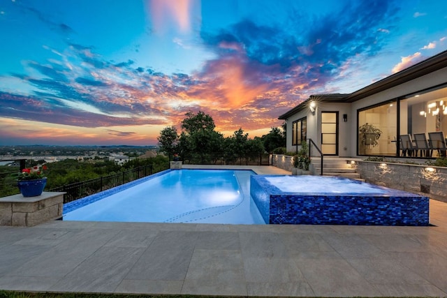 pool at dusk featuring fence and a fenced in pool