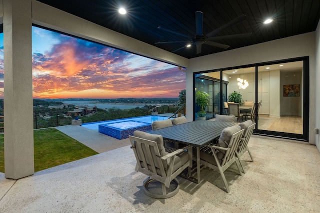 view of patio / terrace featuring an infinity pool, an in ground hot tub, a ceiling fan, and outdoor dining space