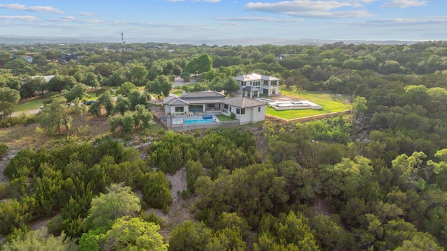 drone / aerial view with a wooded view