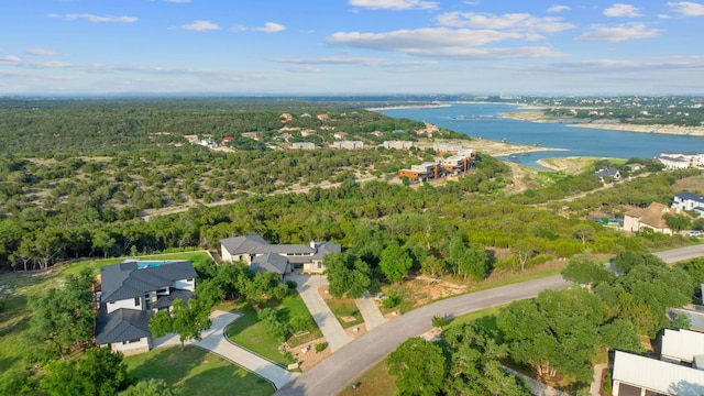drone / aerial view featuring a water view and a wooded view