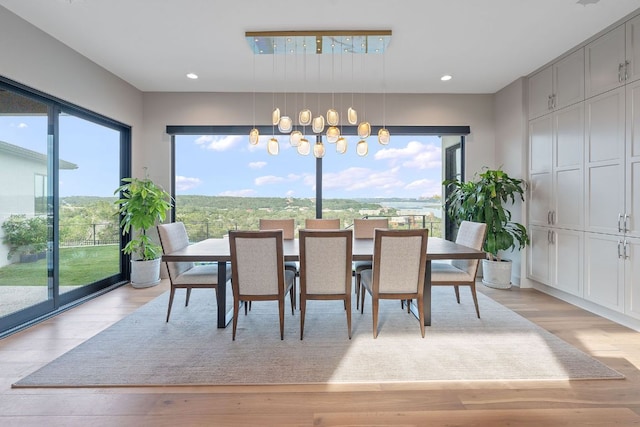dining room featuring recessed lighting, a chandelier, and light wood finished floors