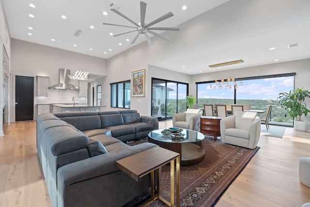 18304 Cedar Sage Ct, Lago Vista, TX 78645 - living room featuring recessed lighting, a ceiling fan, light wood finished floors, and a towering ceiling