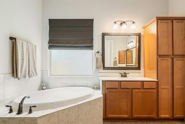 bathroom with a garden tub and vanity
