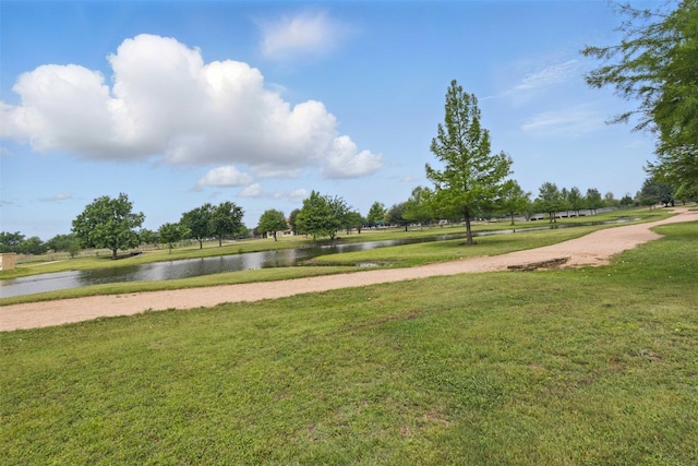 view of community with a water view and a yard