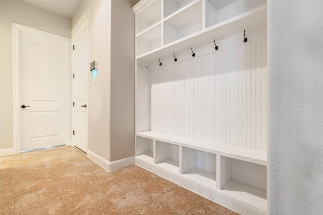 mudroom with baseboards and tile patterned flooring