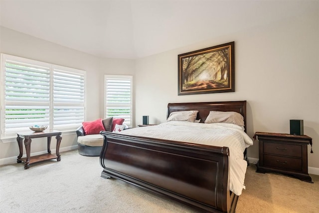 bedroom featuring baseboards and light carpet