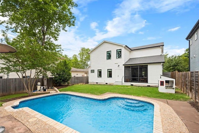 view of swimming pool featuring a yard, a fenced in pool, and a sunroom