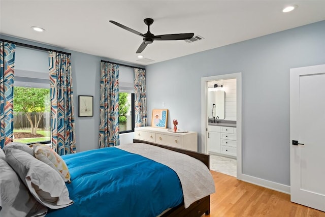bedroom featuring visible vents, recessed lighting, light wood-style floors, and ensuite bathroom