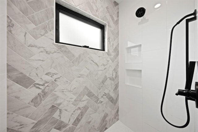 bathroom with a tile shower