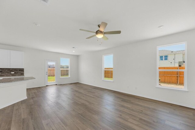 200 Lucky Texan Rd, Jarrell, TX 76537 - unfurnished living room featuring ceiling fan and dark wood-style floors