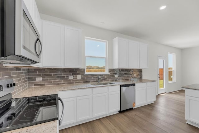 200 Lucky Texan Rd, Jarrell, TX 76537 - kitchen featuring stainless steel appliances, tasteful backsplash, white cabinets, and recessed lighting