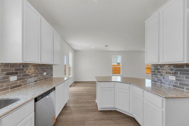 200 Lucky Texan Rd, Jarrell, TX 76537 - kitchen featuring dishwasher, a peninsula, white cabinetry, and decorative backsplash