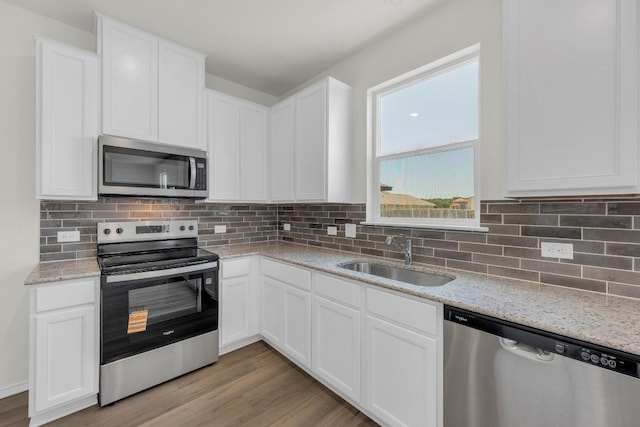 200 Lucky Texan Rd, Jarrell, TX 76537 - kitchen with appliances with stainless steel finishes, white cabinetry, and light wood-style flooring