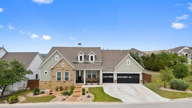 view of front facade featuring a garage, a front lawn, stone siding, a chimney, and concrete driveway