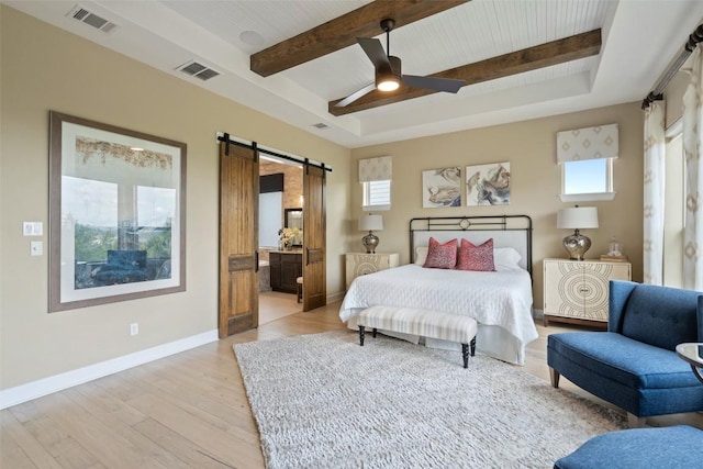 bedroom with visible vents, a barn door, and multiple windows
