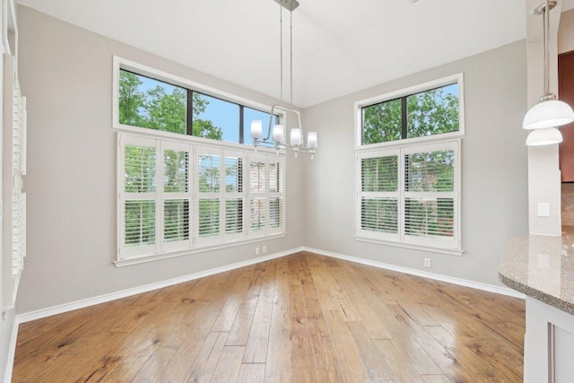 300 San Gabriel Village Blvd Unit 721, Georgetown, TX 78626 - unfurnished dining area with a chandelier, baseboards, and light wood-type flooring