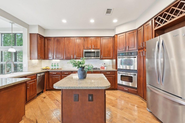 300 San Gabriel Village Blvd Unit 721, Georgetown, TX 78626 - kitchen featuring a sink, tasteful backsplash, stainless steel appliances, and visible vents