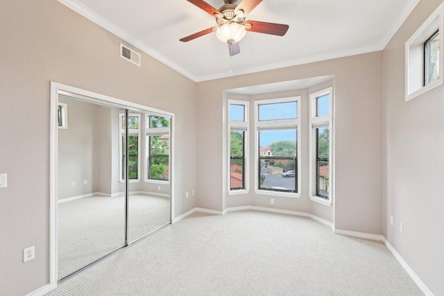 300 San Gabriel Village Blvd Unit 721, Georgetown, TX 78626 - unfurnished bedroom with light carpet, multiple windows, ornamental molding, baseboards, and a closet
