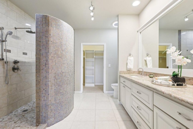 300 San Gabriel Village Blvd Unit 721, Georgetown, TX 78626 - bathroom featuring vanity, walk in shower, a walk in closet, and tile patterned flooring