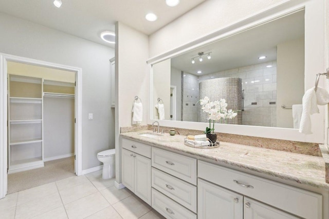 300 San Gabriel Village Blvd Unit 721, Georgetown, TX 78626 - bathroom with vanity, walk in shower, tile patterned floors, toilet, and a walk in closet