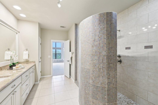 300 San Gabriel Village Blvd Unit 721, Georgetown, TX 78626 - bathroom with vanity, a walk in shower, baseboards, tile patterned floors, and recessed lighting