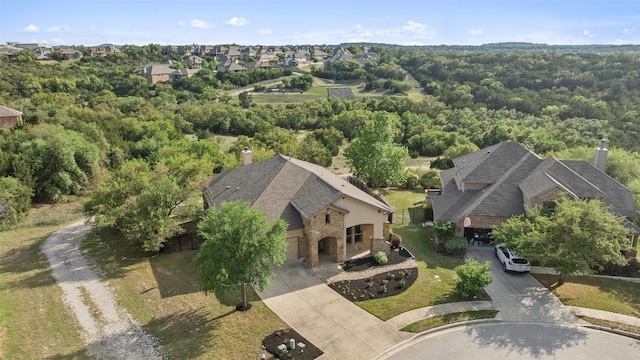 birds eye view of property with a wooded view and a residential view
