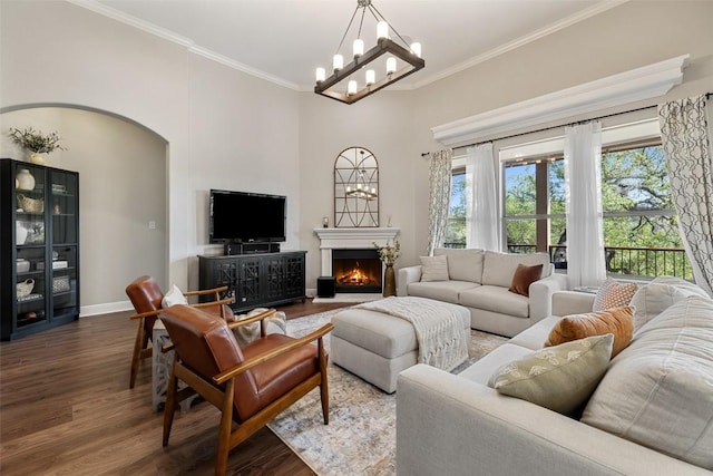 living room with a healthy amount of sunlight, ornamental molding, and wood finished floors