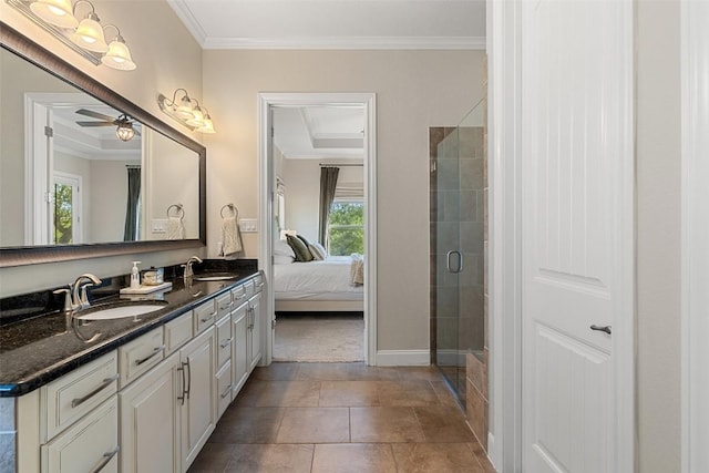 ensuite bathroom featuring double vanity, ornamental molding, a sink, and a stall shower