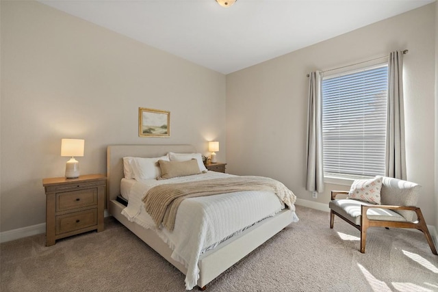 bedroom featuring baseboards and light colored carpet