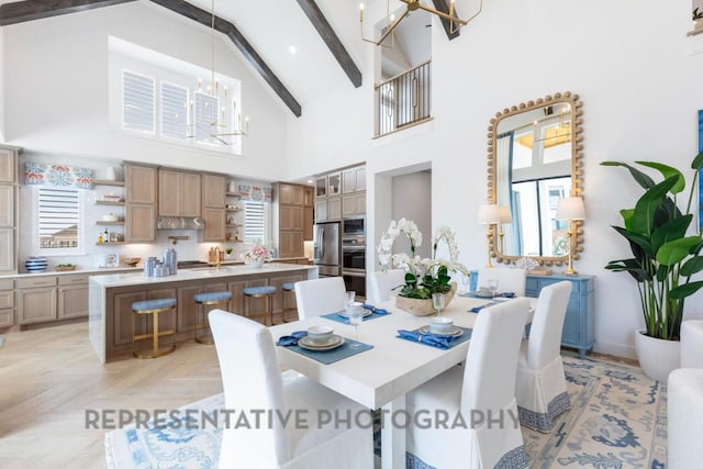 dining area featuring an inviting chandelier, beam ceiling, and high vaulted ceiling