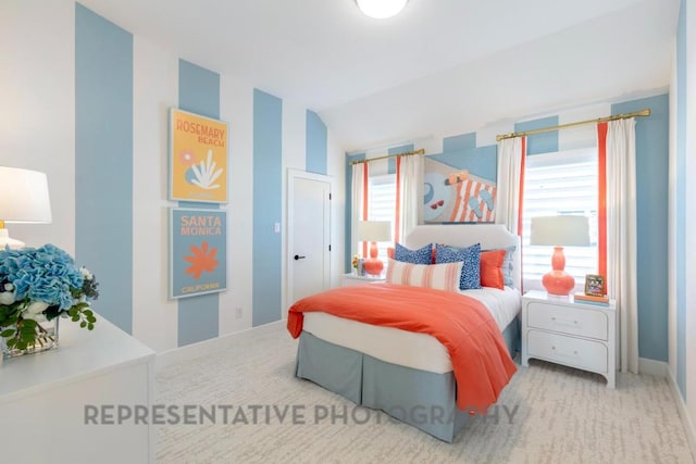 bedroom featuring carpet floors, baseboards, and lofted ceiling