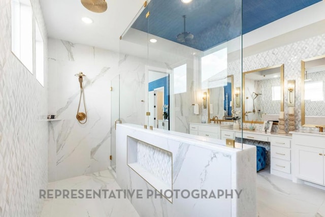851 Old Stone Rd, Austin, TX 78737 - full bathroom featuring marble tiled flooring, a marble finish shower, vanity, wallpapered walls, and recessed lighting