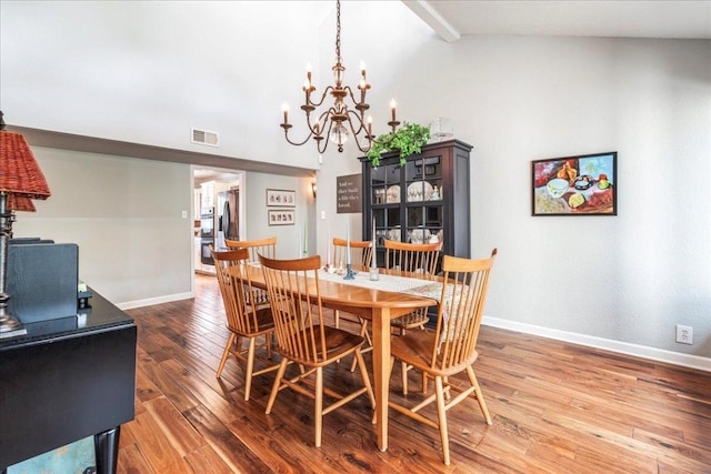 10601 Spicewood Pkwy, Austin, TX 78750 - dining space with wood finished floors, a chandelier, baseboards, and high vaulted ceiling