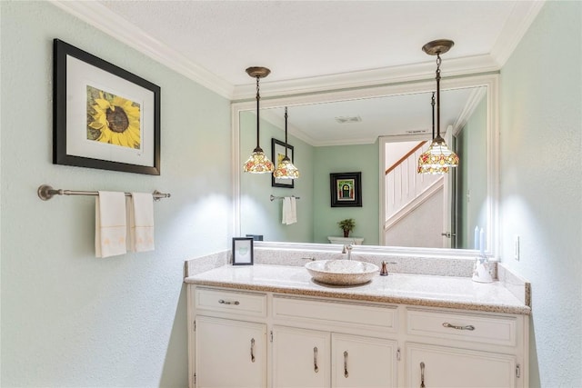 bathroom with vanity, ornamental molding, and visible vents
