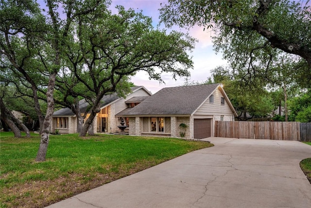 10601 Spicewood Pkwy, Austin, TX 78750 - view of front of house featuring driveway, an attached garage, french doors, and brick siding