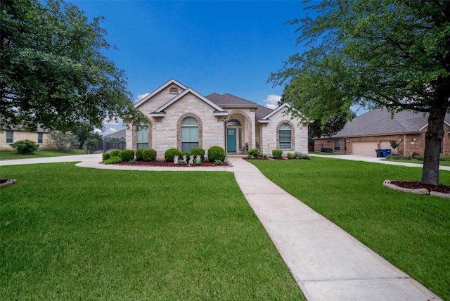 view of front facade with a front yard and stone siding