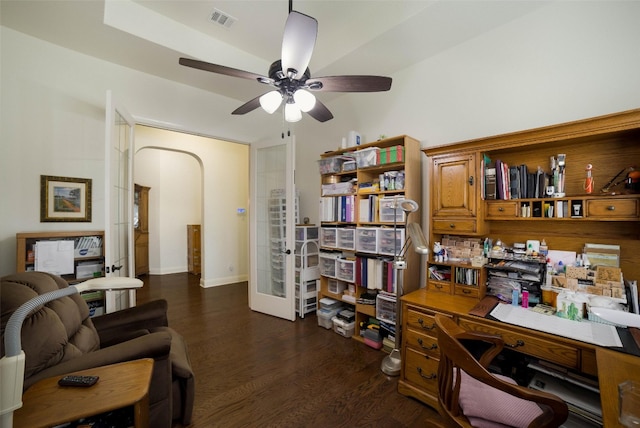 office with arched walkways, a ceiling fan, dark wood finished floors, and visible vents